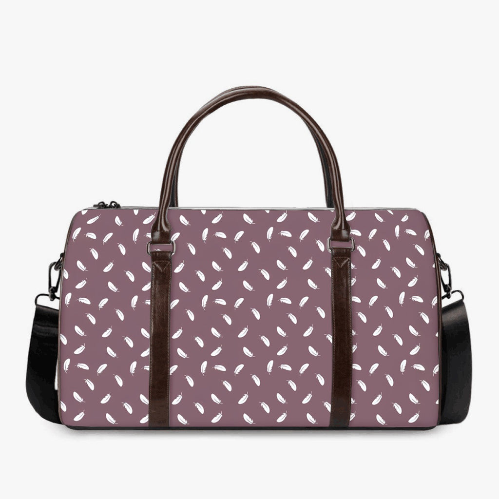Purple duffel bag with white pattern and brown handles on a white background