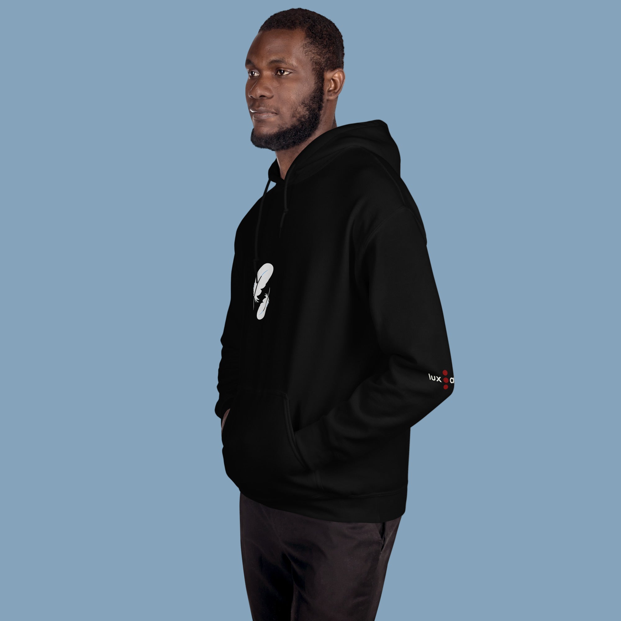 Man wearing a black hoodie with logos on the sleeves against a white background