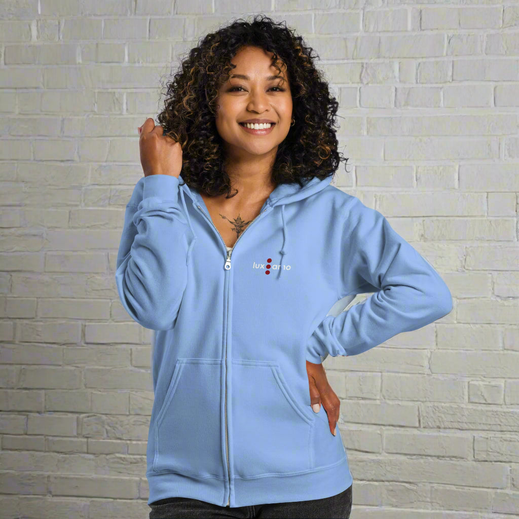 Woman wearing a light blue hoodie with a logo on a white background