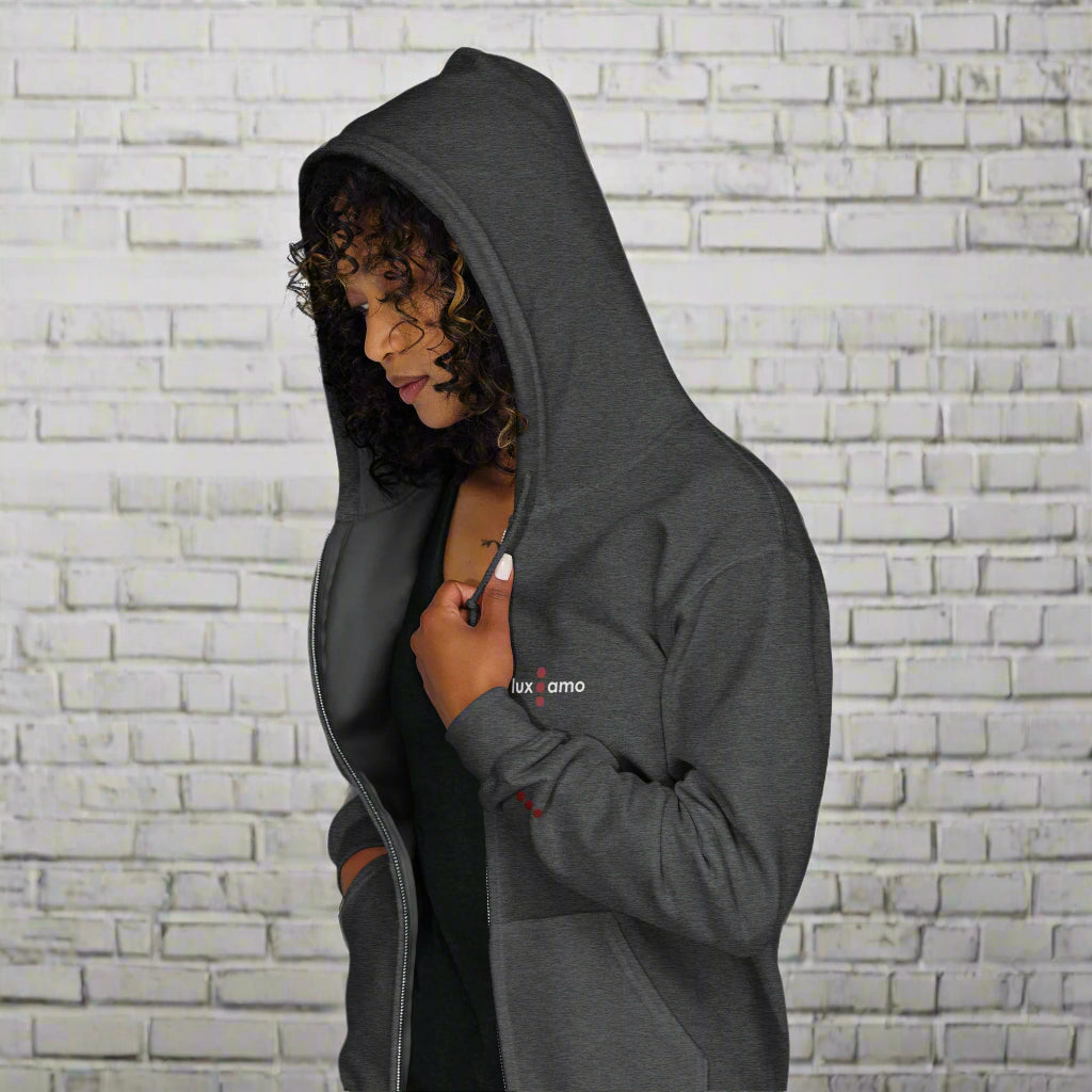 Person wearing a gray hoodie with a brand logo on a white background