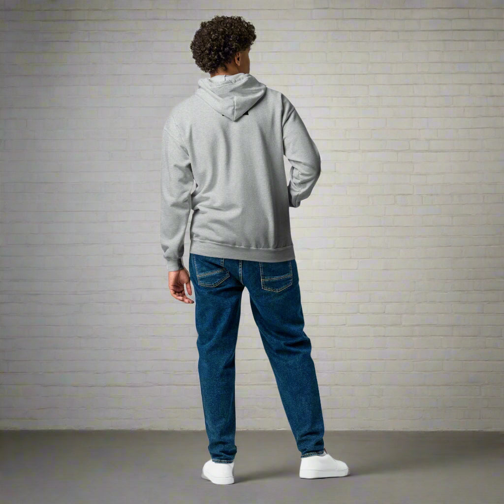 Person wearing a gray hoodie and blue jeans on a white background