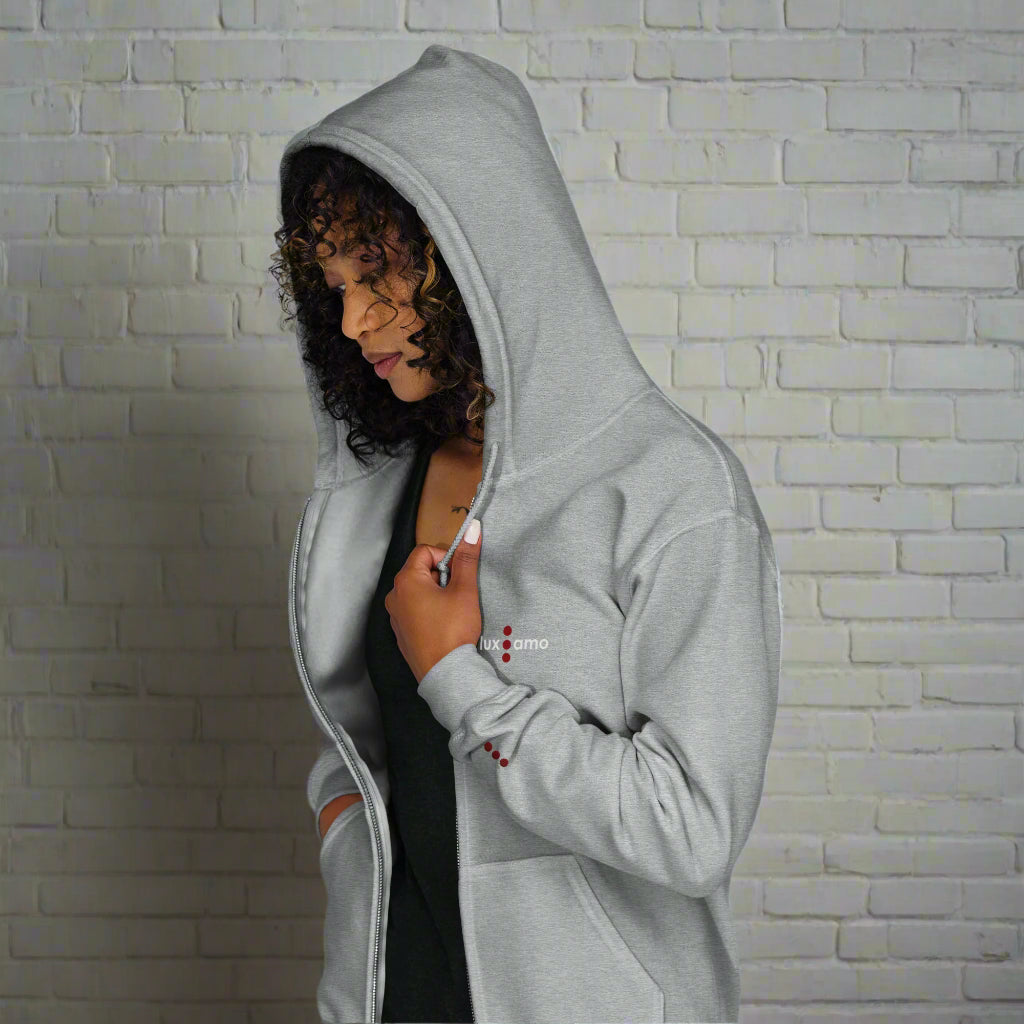 Person wearing a gray hoodie with a white background